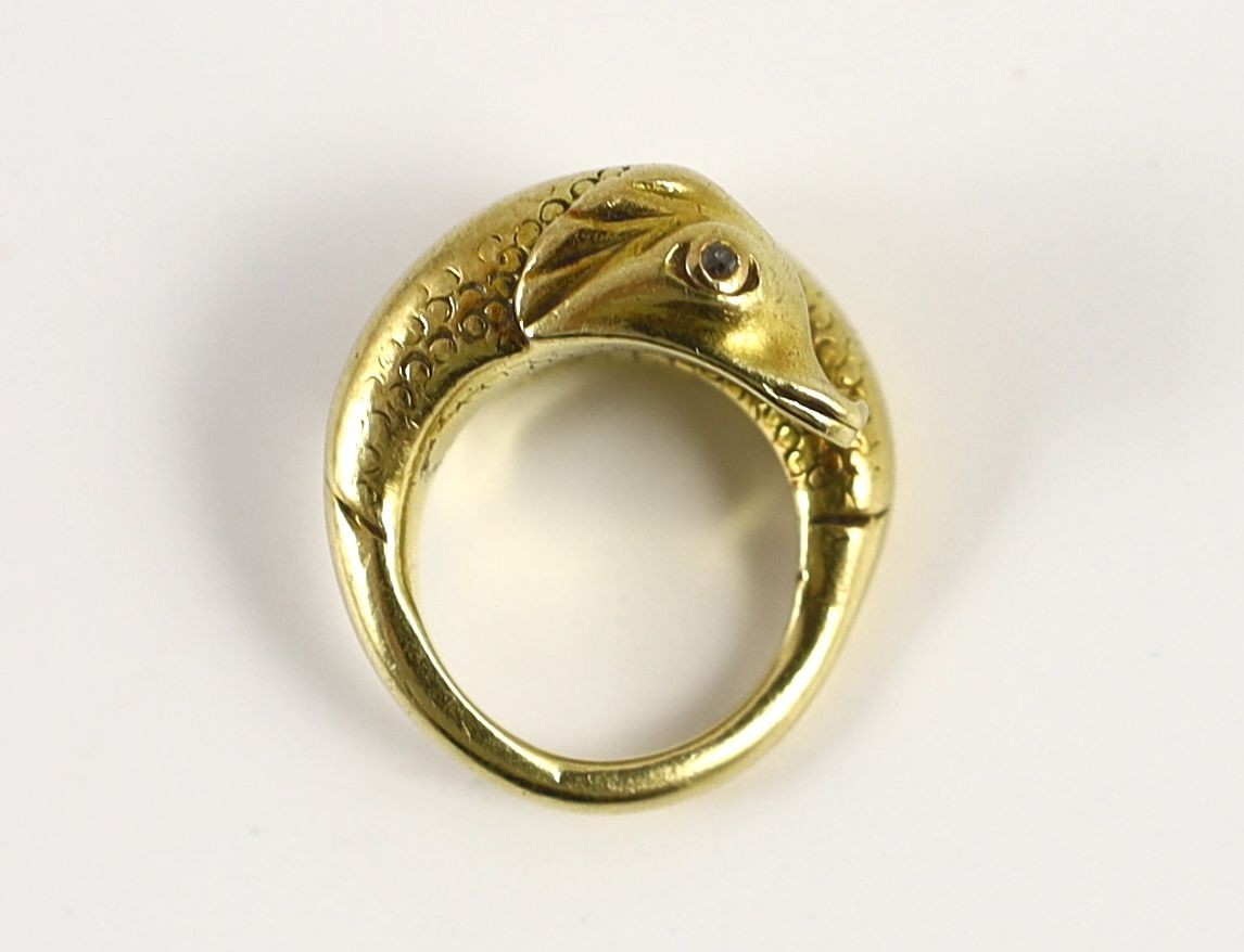 An early 20th century continental gold and diamond chip set twin dolphin crossover ring